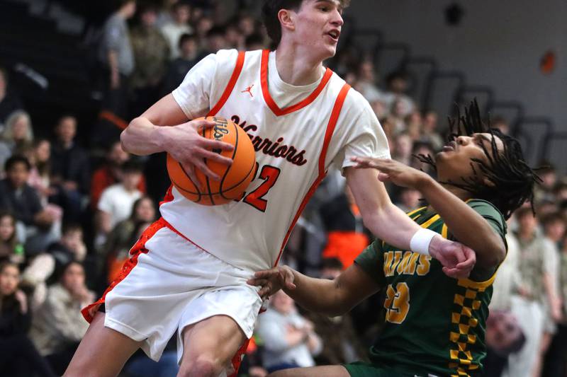 McHenry’s Blake Renfro, left, collides with Crystal Lake South’s David McFadden in varsity boys basketball on Friday, Feb. 20, 2026, at McHenry High School in McHenry.