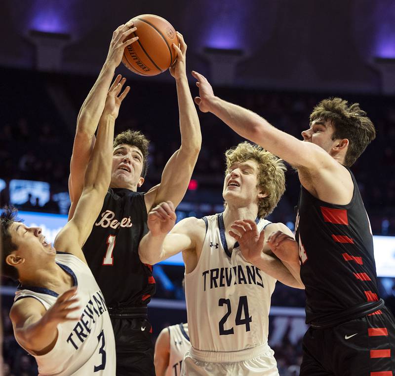 Benet Academy’s Sam Driscoll battle New Trier’s Jun Yoshitani (left), Ian Brown and teammate Parker Sulaver for a rebound Friday March 10, 2023 during the 4A IHSA Boys Basketball semifinals.