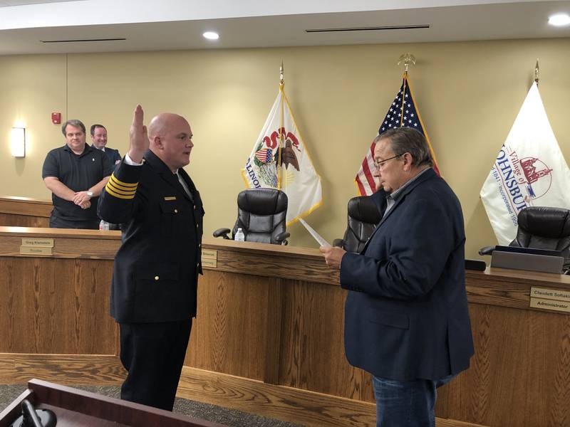 Jason Greenwald, left, was sworn in as Johnsburg's interim police chief on Tuesday, Sept. 26, 2023, by Village President Ed Hettermann.