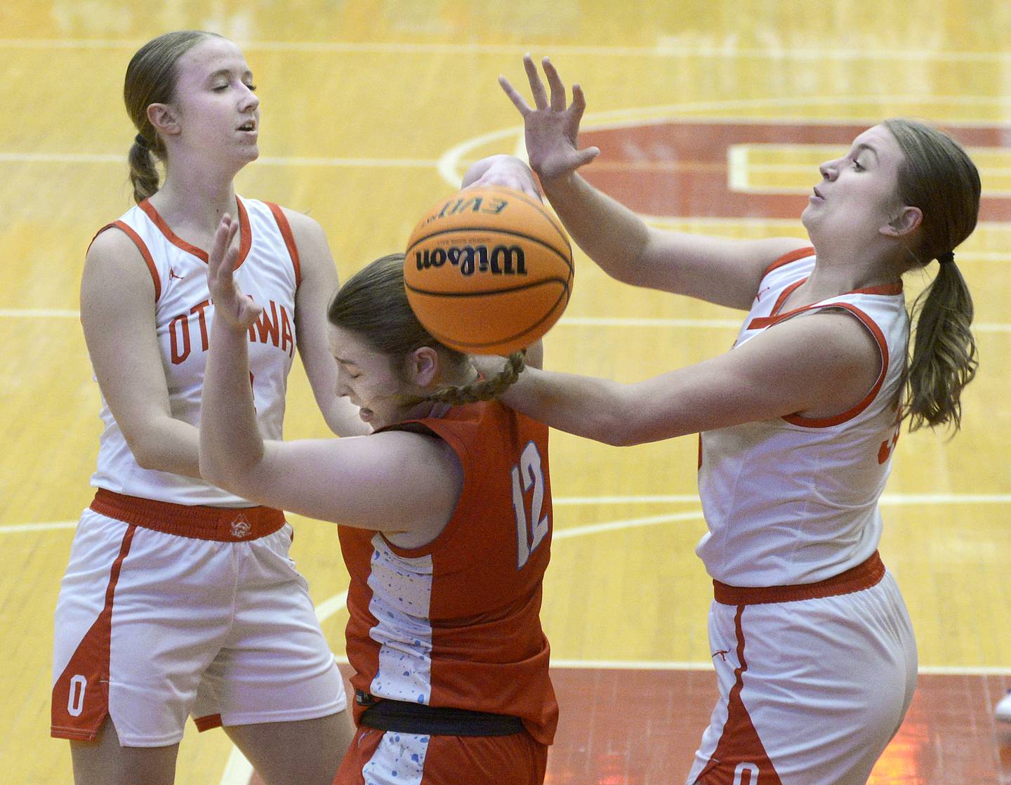 Ottawa’s Skylar Dorsey and Charley Maierhofer battle Streator’s Keah Krohe for a rebound in the 2nd period Thursday at Ottawa.
