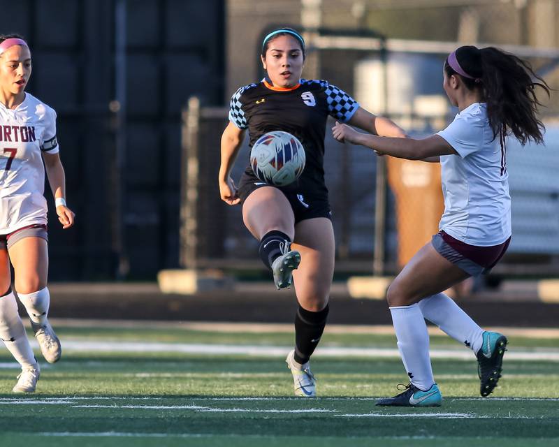 Willowbrook's Natalia Garcia-Avila (9) kicks the ball away from Morton's Emily orduna (11) during soccer match between Morton at Willowbrook.  April 15, 2024.