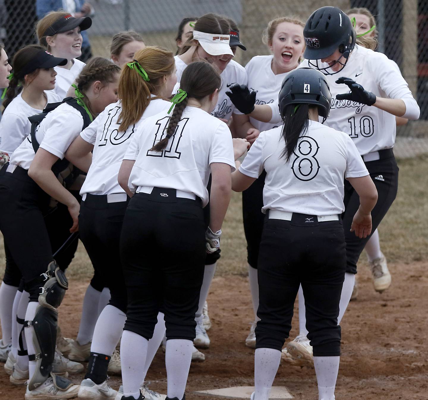 Huntley’s Jori Heard is surrounded by her teammates as she celebrates her home run during a non-conference softball game Thursday March 17, 2022, between Huntley and Fremd at Huntley High School.