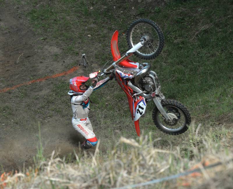 A rider flips their bike during an attempt to climb the hill at the Rock River Riders Motorcycle Club's Father's Day Hillclimb on Sunday, June 15, 2025.