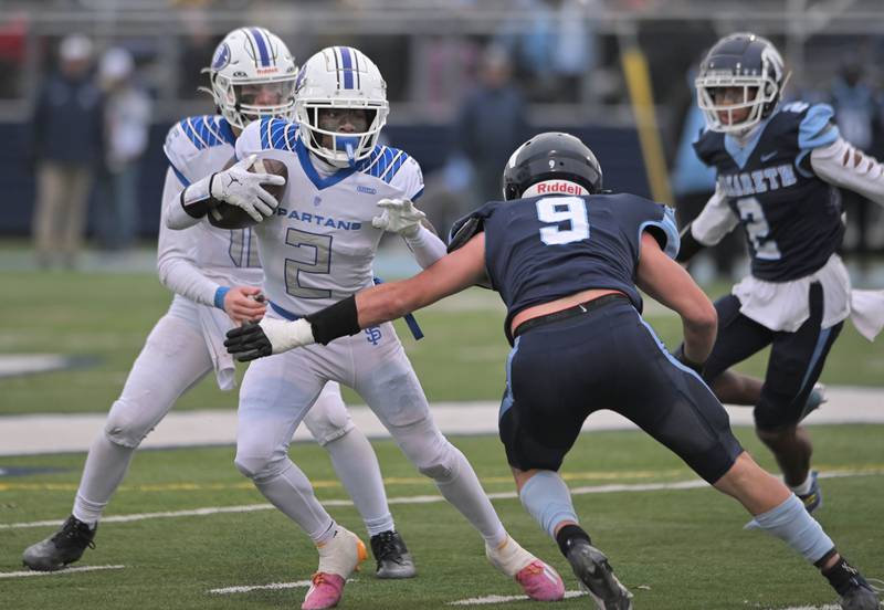St. Francis’ Ian Willis jukwa Nazareth’s Nolan Daly on a late-game touchdown run in the IHSA Class 5A state semifinal football game in La Grange on Saturday, Nov. 23, 2024.