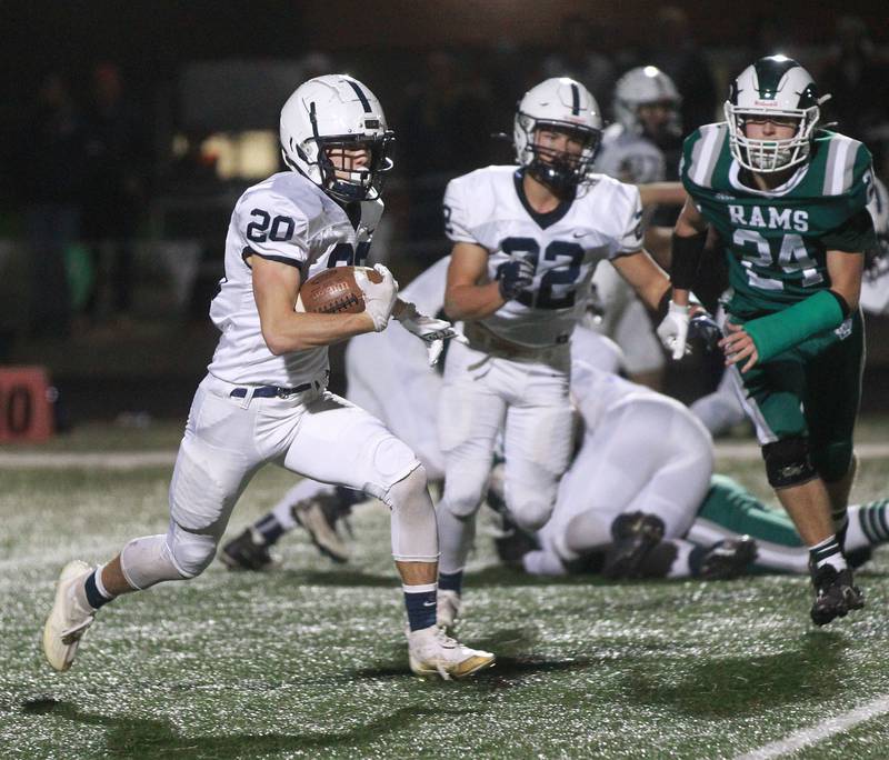 Cary-Grove's Drew Magel runs the ball against Grayslake Central's Connor Anguilm (#24) in the second quarter during the Class 6A second-round football game at Grayslake Central.
