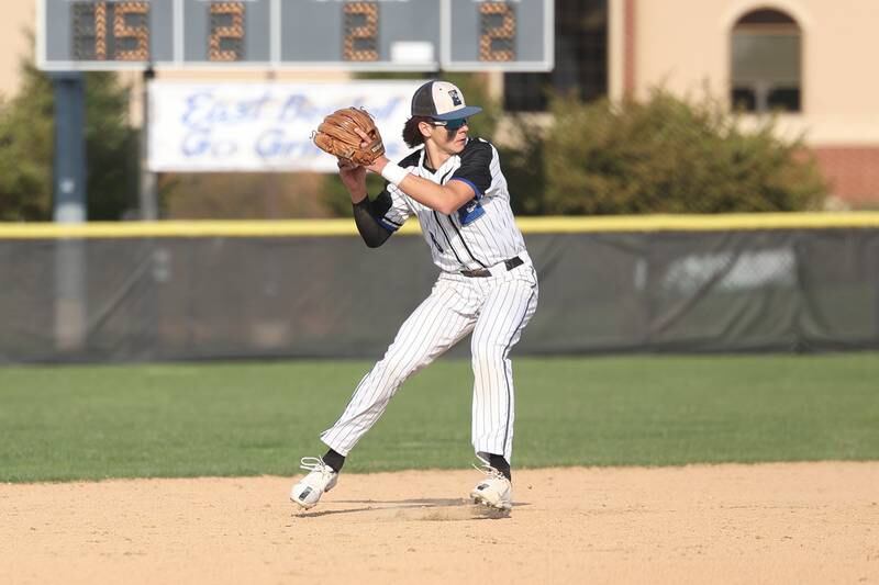 Lincoln-Way East’s Tyler Bell throws to first for the out against Lincoln-Way West on Monday, April 24, 2023 in Frankfort.