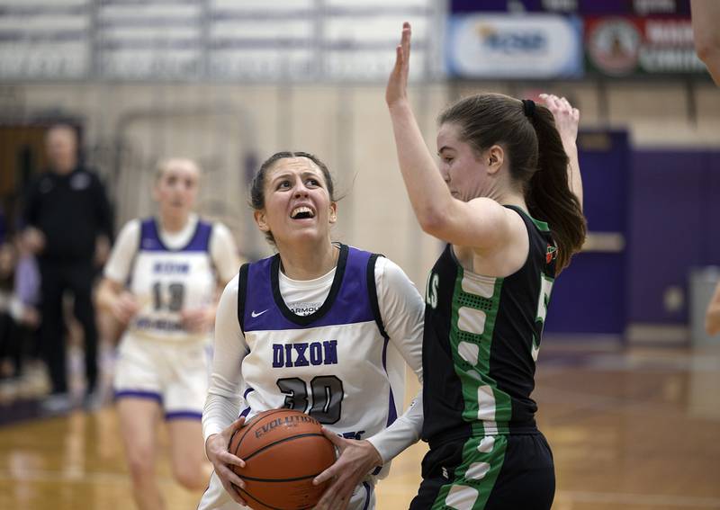 Dixon’s Harvest Day looks to put up a shot against Rock Falls’ Rylee Johnson Wednesday, Feb. 1, 2023.