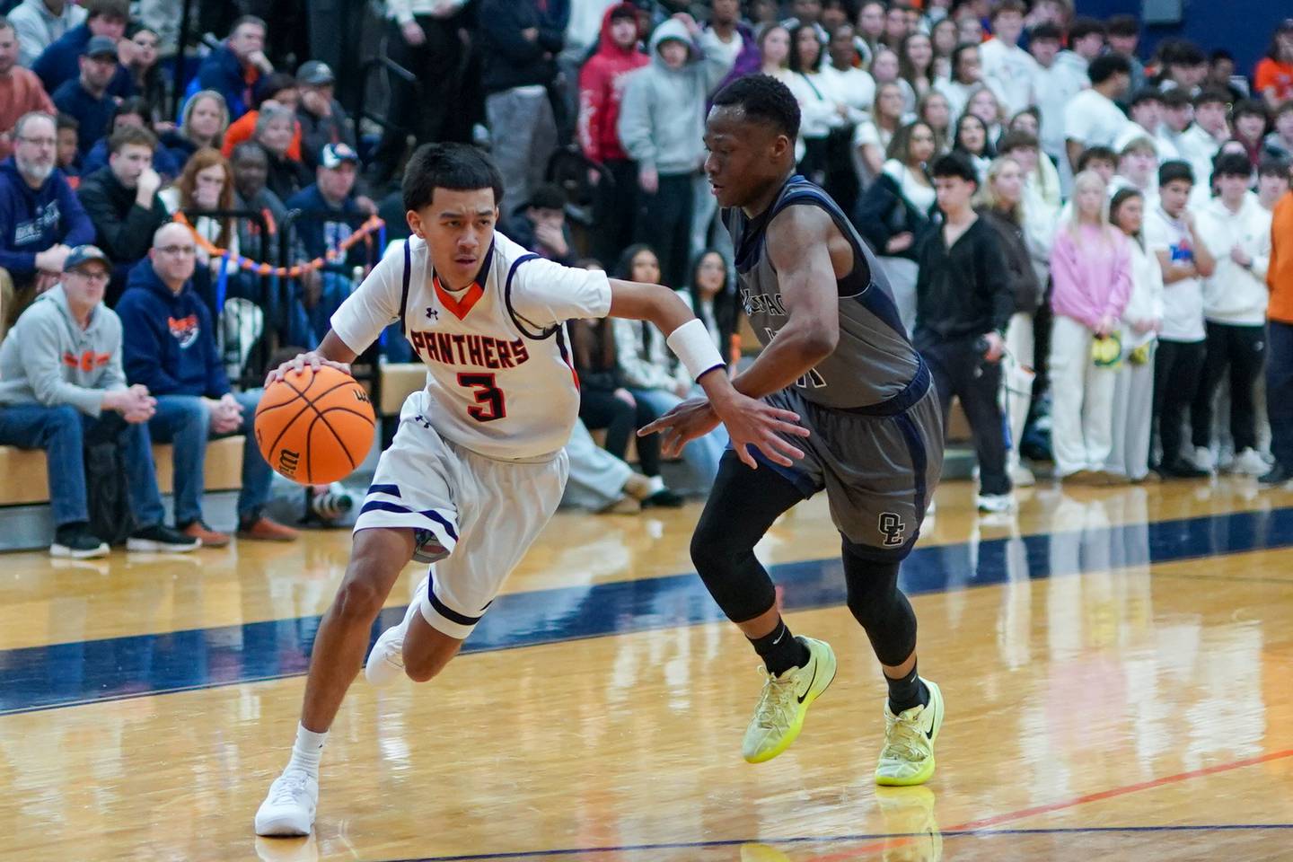 Oswego’s Ethan Vahl (3) drives to the hoop against Oswego East's Reginald McWaine (11) during a basketball game at Oswego High School on Tuesday, February 18, 2025.