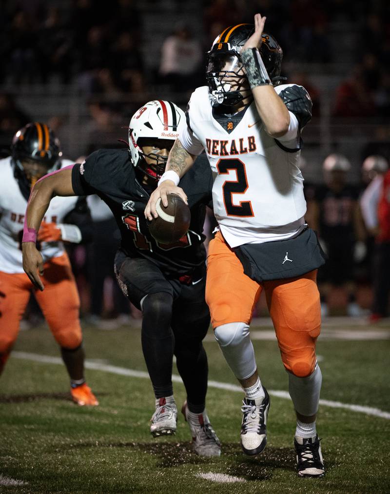 Dekalb's Cole Latimer looks for an open man down field as Bradley-Bourbonnais' Ty Thurmond closes in on him in a game on Friday, October 10, 2025.