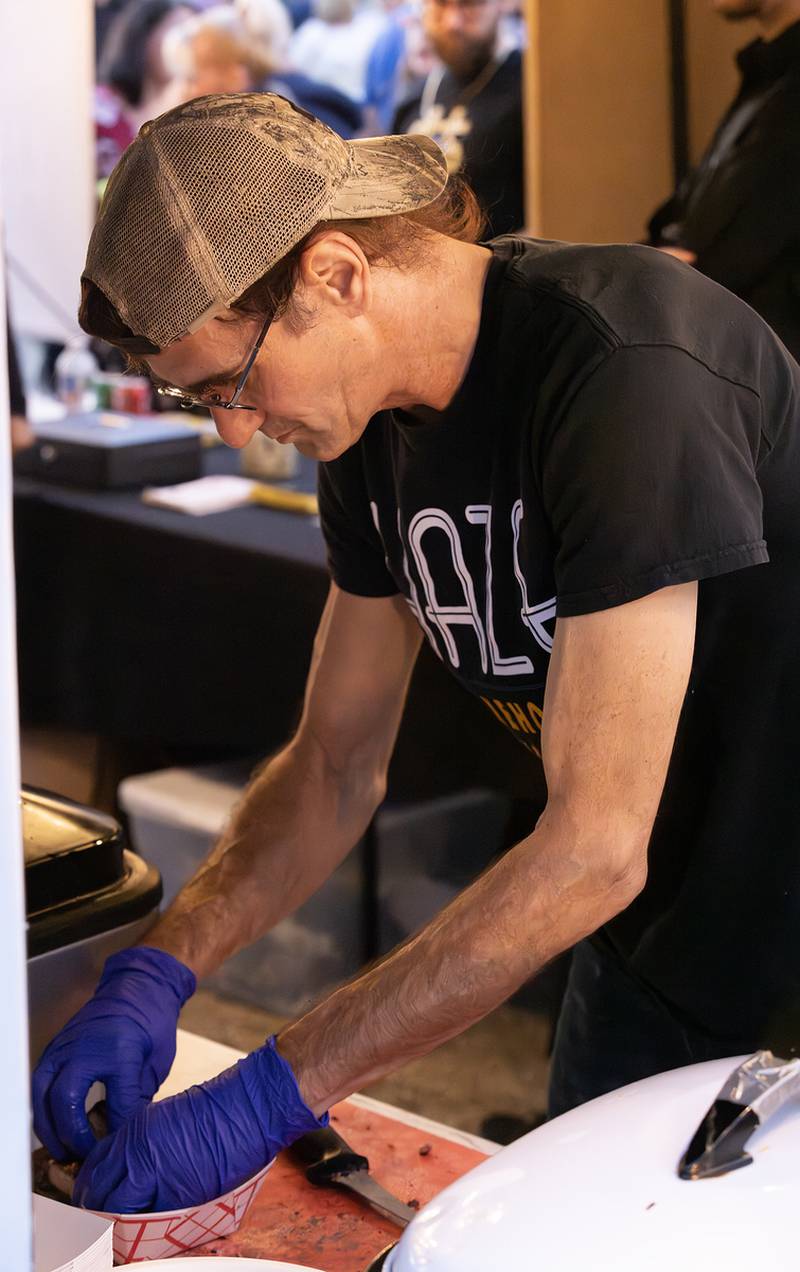 Michael Redman of Haze Smokehouse prepares an order of three bone ribs on Saturday, Sept. 9, 2023 at the LaSalle Business Association's Jazz'N the Street event.