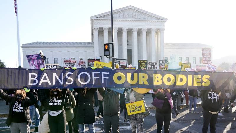 People demonstrate in front of the U.S. Supreme Court