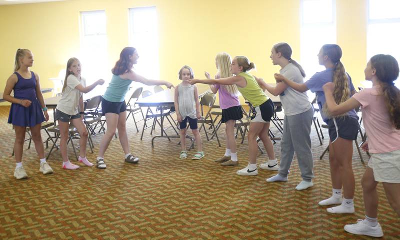 The cast of Annie Jr. rehearses for the upcoming musical on Tuesday, June 24, 2025 at the First United Methodist Church in Henry. The show will be presented July 25-27 at the River Valley Players theater in Henry, .