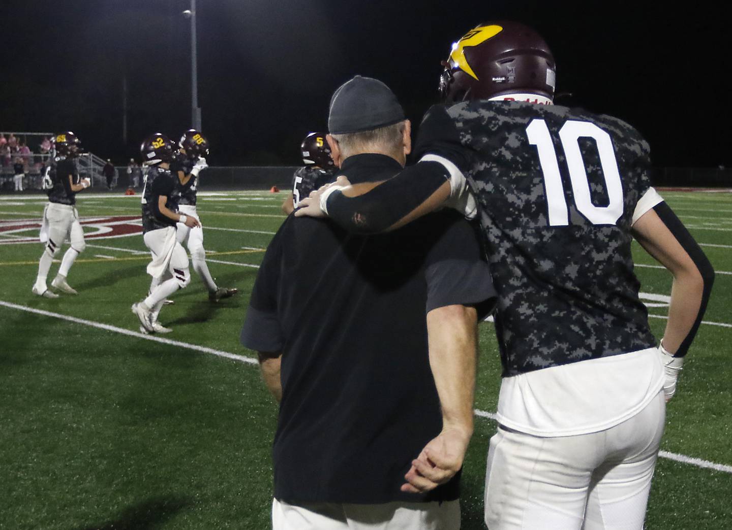 Richmond-Burton's Luke Robinson hugs Richmond-Burton Head Coach Mike Noll after Noll won his 300 career football game a on Friday, Oct. 17, 2025, at Richmond-Burton High School in Richmond.