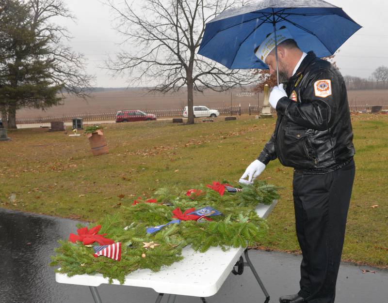 Oregon VFW Commander Brian Beckman checks over the military division wreaths during the Wreaths Across America event at Daysville Cemetery. east of Oregon, on Saturday, Dec. 16, 2023.