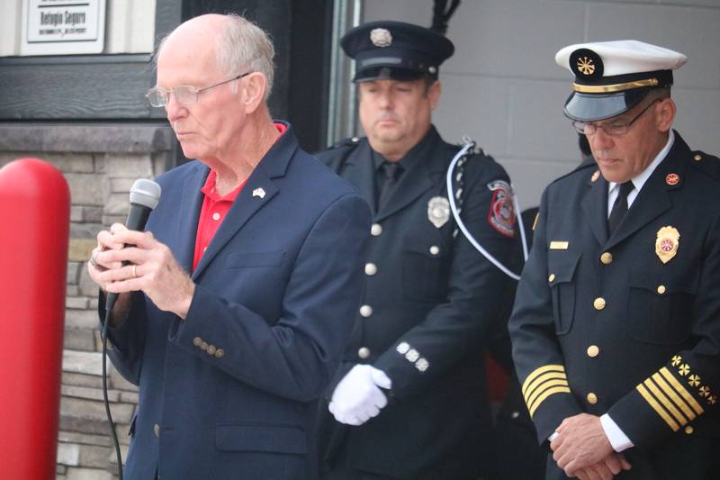 DeKalb Fire Department chaplain Ray Krueger (left) offers prayer Sept. 11, 2025, during the fire department's annual Patriot Day Ceremony.