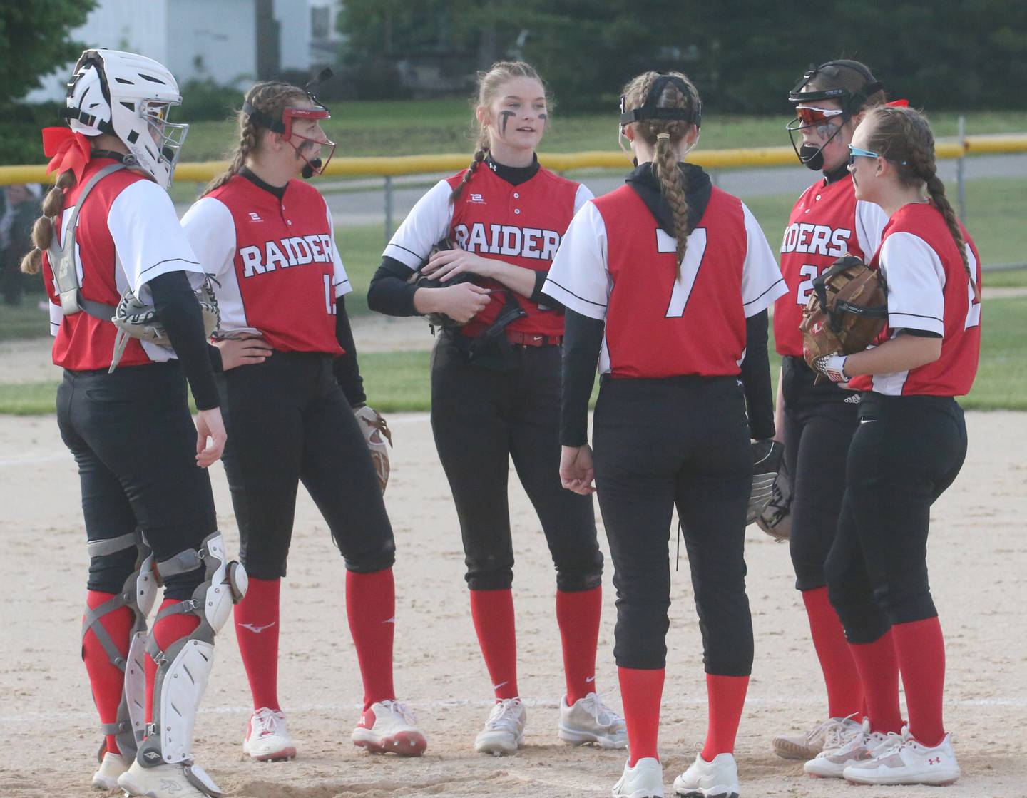 Members of the Earlville softball team chat on the mound while playing Newark during the Class 1A Regional final on Thursday, May 22, 2025 at Indian Creek High School in Shabbona.