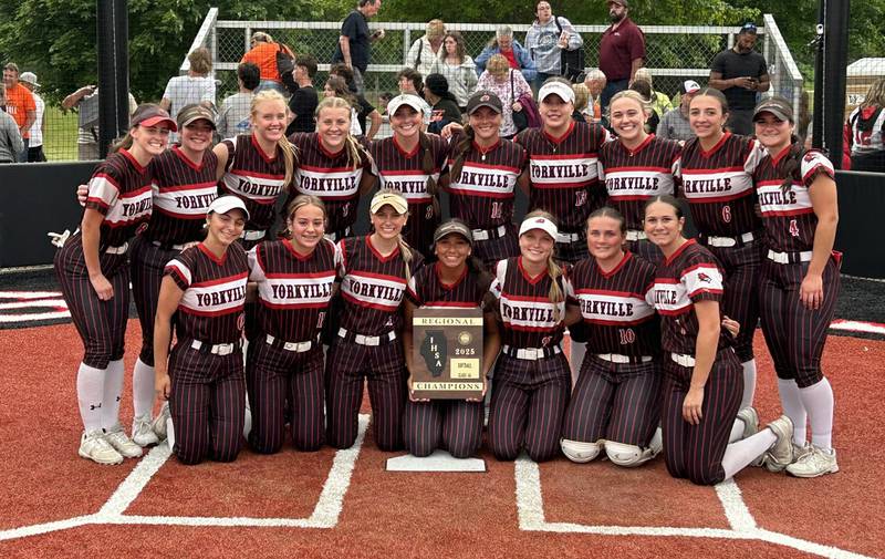 The Yorkville softball poses with the regional plaque after beating Plainfield East to win the Class 4A Yorkville Regional.