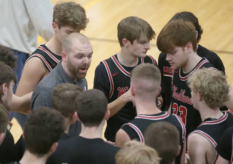 Woodland head boys basketball head coach Connor Kaminke talks to his team during a timeout during the Tri-County Conference Tournament on Thursday, Jan. 25, 2024 at Putnam County High School.