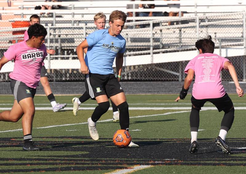A Sycamore player pushes the ball up field against Sycamore Monday, July 14, 2025, during a summer boys soccer friendly at DeKalb High School.