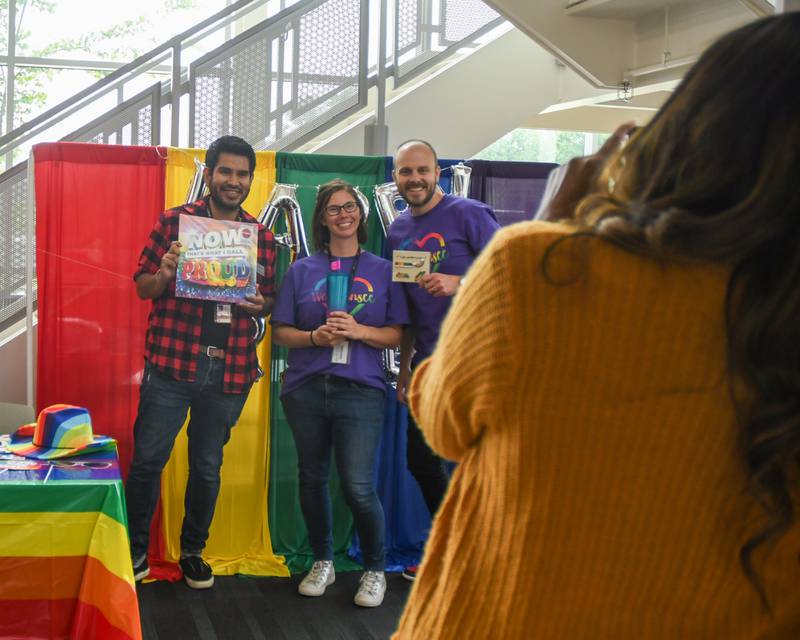 Waubonsee Community College employees Jonatan Gutierrez Urzua, left, Jessica Kellenberger and Spencer Brayton all pose for a photo with their raffle prizes they had won during the pride party held at Waubonsee Community College in Plano held on Thursday June 29, 2023.