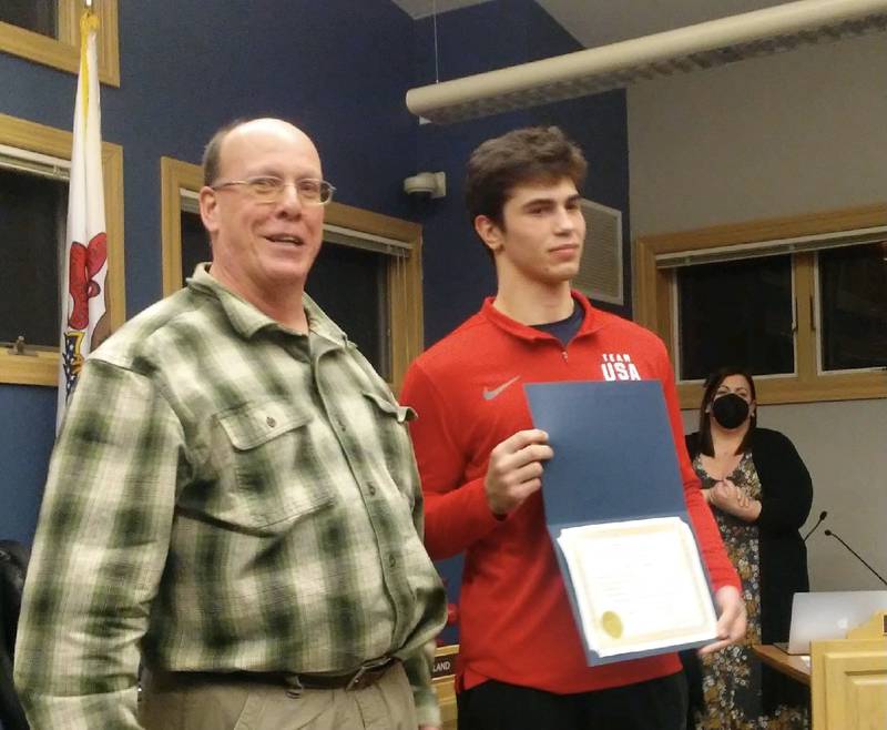 Judo champion Alex Knauf of Yorkville displays an award from Mayor John Purcell at the Feb. 8, 2022 Yorkville City Council meeting after winning a tournament in Colombia, South America. (Mark Foster -- mfoster@shawmedia.com)