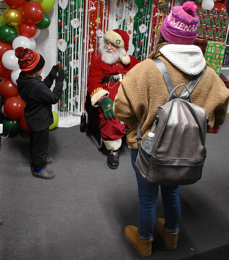 Blaine Grell, 4, of Rock Falls tells Santa what he wants for Christmas during Rock Falls’ Hometown Holidays Christmas Walk, Friday, Nov. 21, 2025.