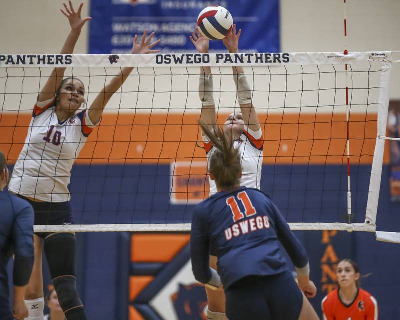 Romeoville's Talynn Miloch (17) blocks a shot at the net during volleyball match between Romeoville at Oswego. Oct 16, 2025.