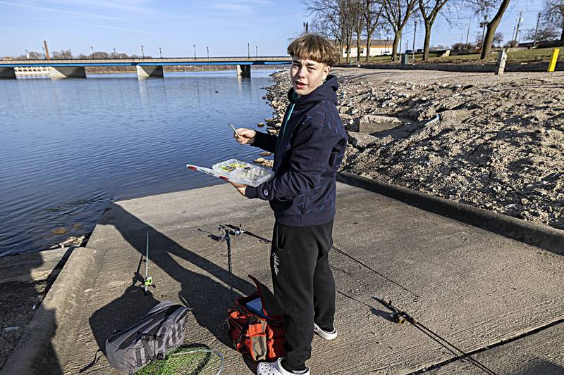Avery Winge of Sterling talks about his fishing exploits Wednesday, Dec. 20, 2023 while trying his luck at the lower dam in Rock Falls. The mild weather was great for fishing but bad for a potential white Christmas.