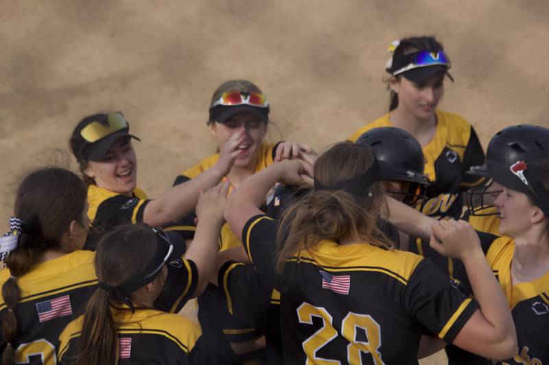 Joliet West catcher Caitlynn Baranak celebrates with her team after her homer into left vs Plainfield North on April 22.