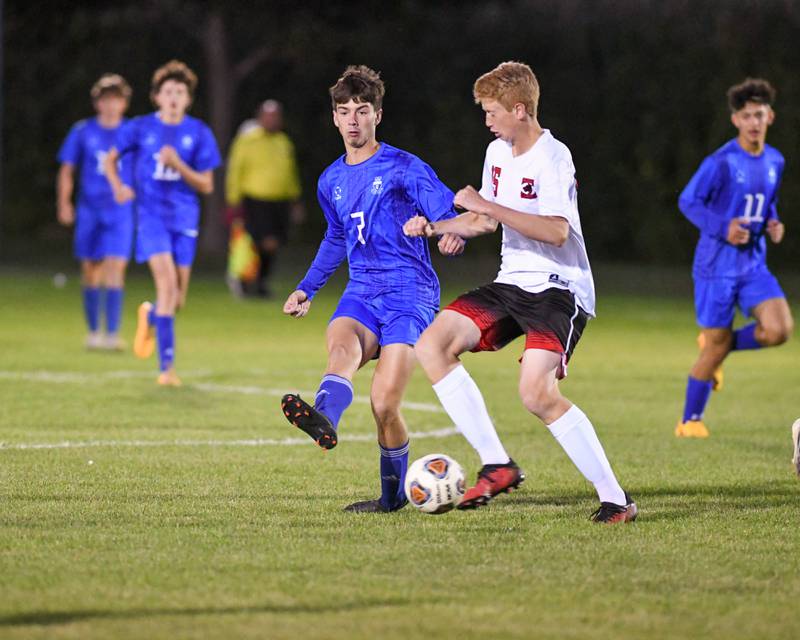 Hinckley-Big Rock’s Landon Roop, left, kicks the ball away from Indian Creek Kason Murry in the second half of the game on Monday Sept. 26th held at Hinckley-Big Rock High School.
