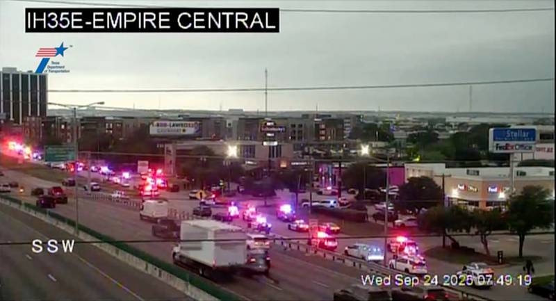 This traffic camera image shows  heavy police presence off I-35E close to a U.S. Immigration and Customs Enforcement office, in northwest Dallas on Wednesday, Sept. 24, 2025.  (WFAA via AP)
