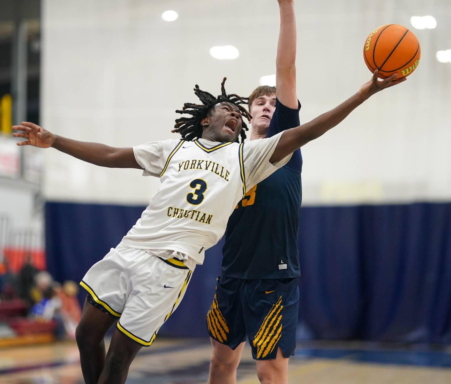 Yorkville Christian's Jayden Riley (3) shoots the ball along the baseline against Neuqua Valley's Cole Kelly (23) during a basketball game at Yorkville Christian High School on Tuesday, February 4, 2025.