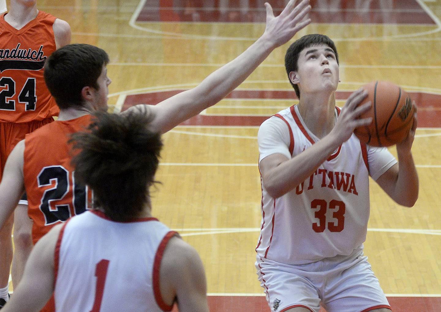 Sandwich’s Owen Shelly attempts to block as Ottawa’s Cooper Knoll eyes the basket in the first period on Tuesday, Jan. 3, 2023 at Ottawa High School.