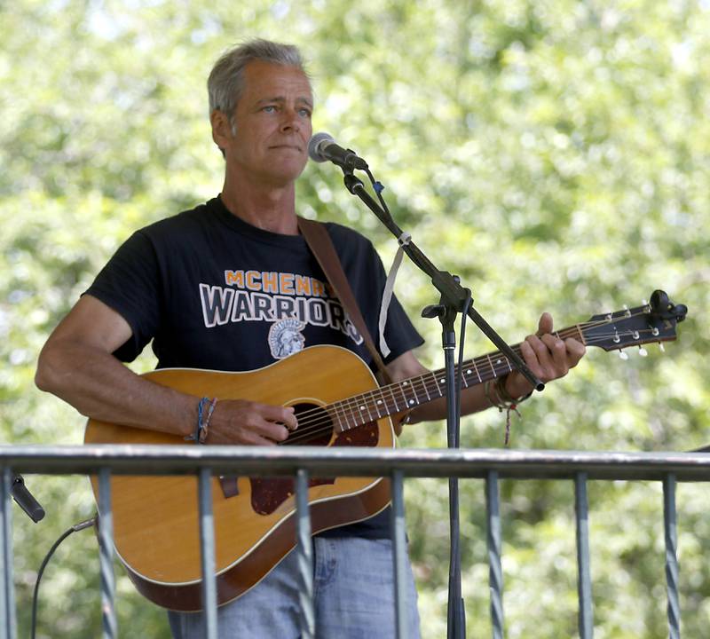 Mark Hobbs of McHenry sings Tuesday, June 20, 2023, at a Summer Woodstock Farmers Market around the Historic Woodstock Square. People were able to shop from over 40 of their favorite farms & producers for in-season food fresh produce, dairy, meats, breads, baked goods, spices, herbs, pasta, flowers and more.