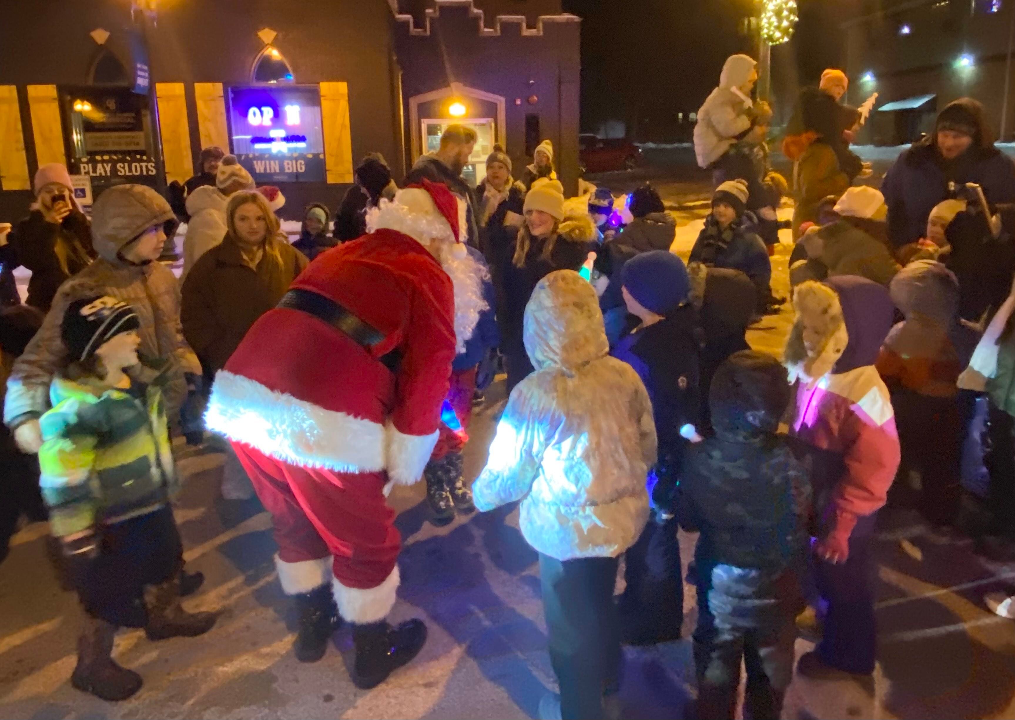 Santa Claus greets waiting children eager to tell him what they want for Christmas on Friday, Dec. 5, 2025, at the Sycamore Chamber of Commerce's annual Walk with Santa in downtown Sycamore.