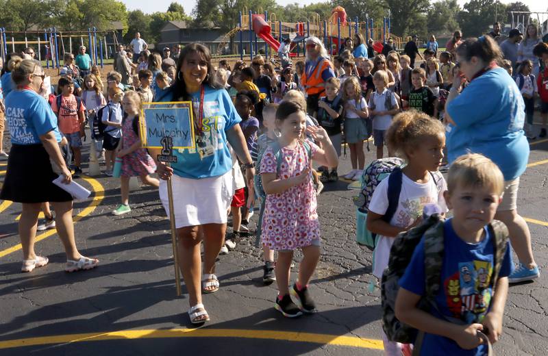 Students and teachers walk into the school for the first day of school at West Elementary School in Crystal Lake on Wednesday, Aug. 16, 2023.
