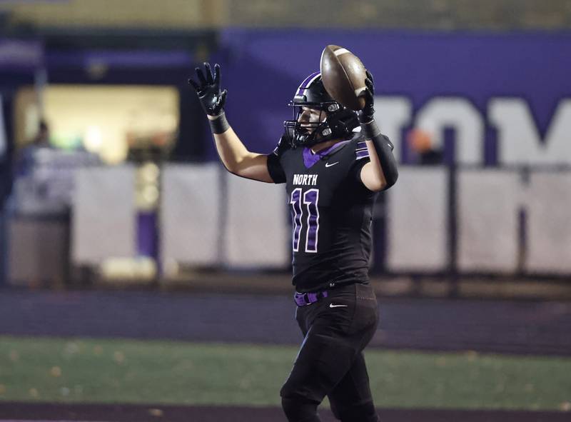 Downers Grove North's Charlie Cruse (11) celebrates after scoring a touchdown during the 7A first-round playoff game between Wheaton Warrenville South and Downers Grove North high schools on Friday, Nov. 1, 2024 in Downers Grove.