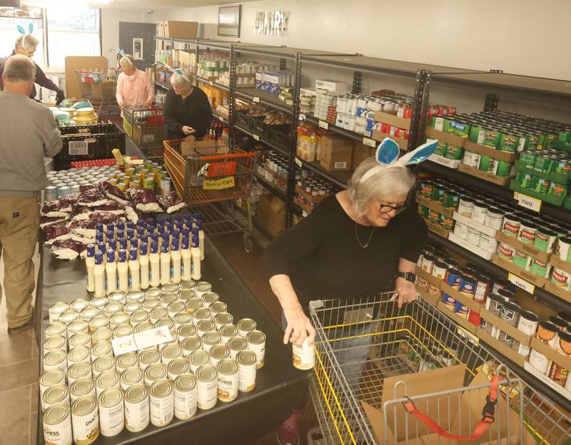 Volunteers fill carts of food during the annual Easter distribution on Wednesday, April 1, 2026 at the Hall Township Food Pantry in Spring Valley.