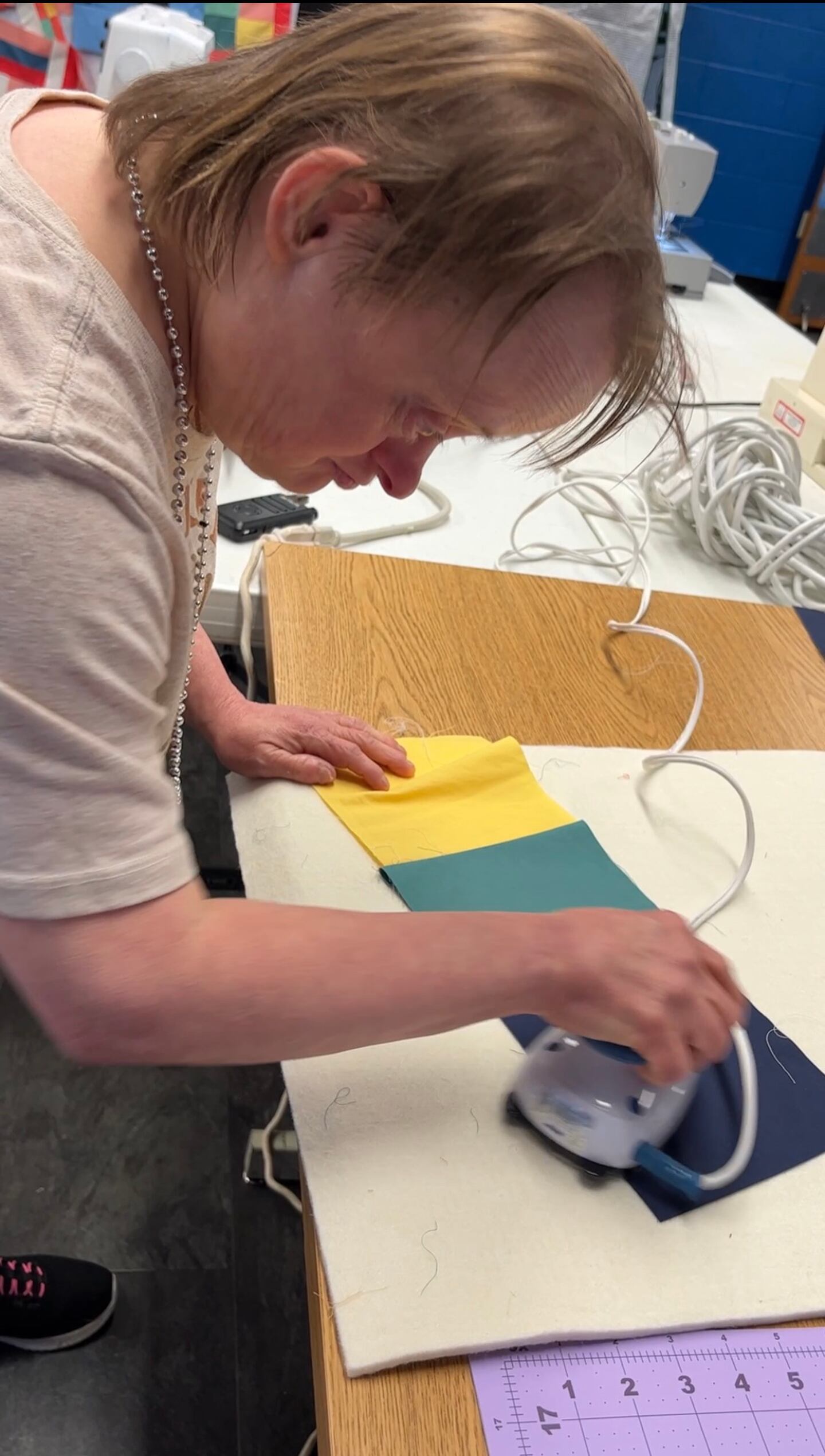 Ruth Bardack, a client at  UCP-Center for Disability Services in Joliet, carefully irons her quilt pieces for the large, client-created quilt that will be part of a live auction at the  28th Great Chefs Tasting and Auction on March 2.
