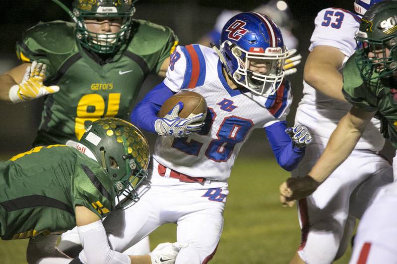 Crystal Lake South linebacker Drew Murtaugh (11) tackles Dundee-Crown running back Gregory Williams (28) during the game at Crystal Lake South High School on Friday, Oct. 2, 2015.