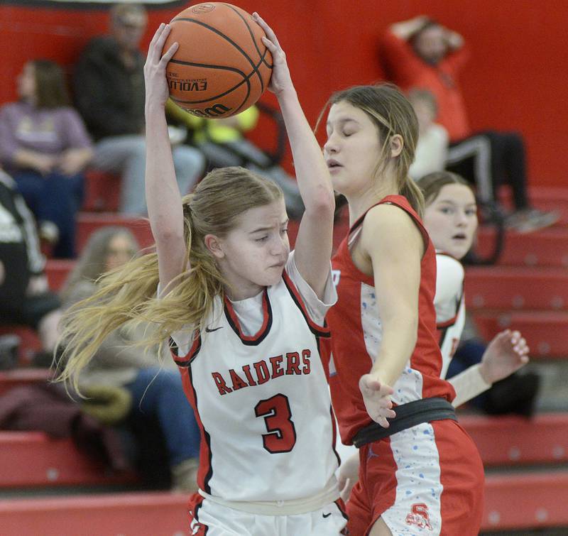 Earlville's Jacey Helgesen brings down the rebound ahead of Streator’s Rhea Huey in the second quarter Saturday at Earlville.