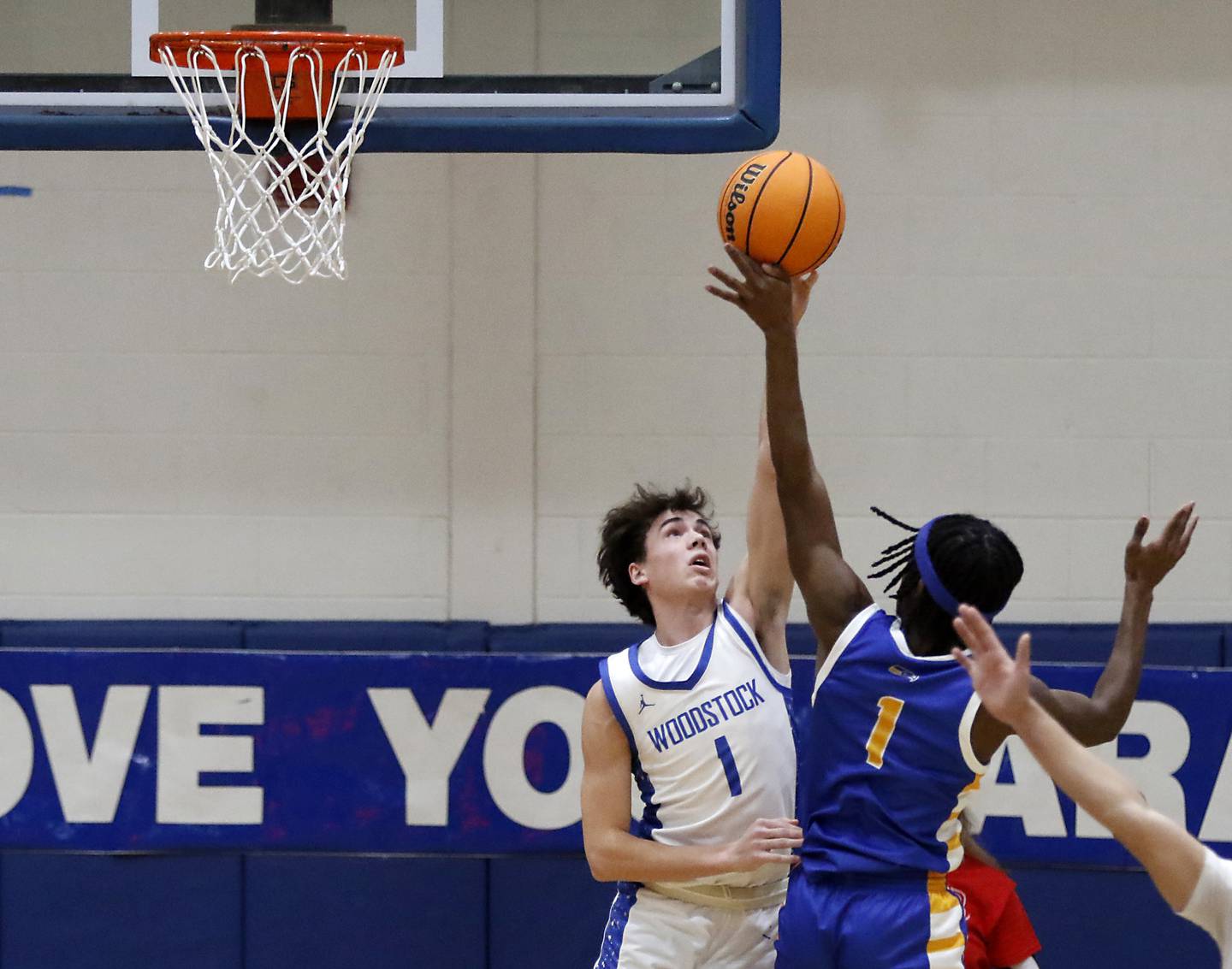 Woodstock's Collin Greenlee blocks the shot of Johnsburg's Jarrel Albea during a Kishwaukee River Conference basketball game on Friday,  Feb. 14, 2025, at Woodstock High School.