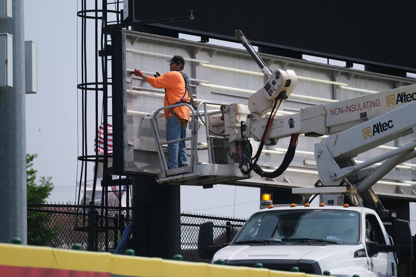 A worker install new lights on the scoreboard before the home opener on May 13th at Duly Health and Care Stadium home of the Joliet Slammers baseball team. Tuesday, May 10, 2022, in Joliet.