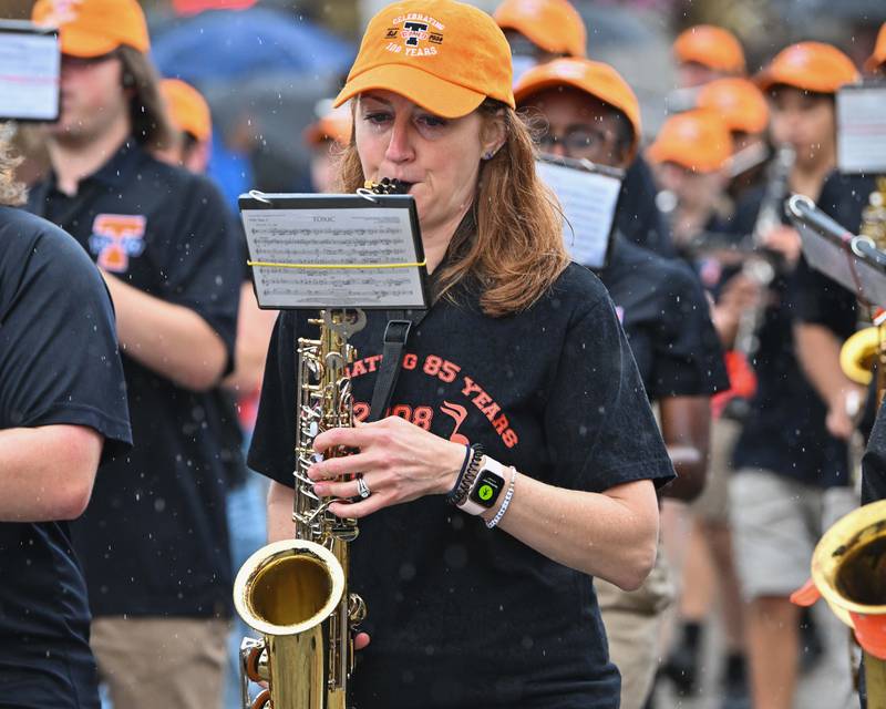 Crystal Lake Central High School's alumni join the school's Marching Tiger Band as seen in downtown Crystal Lake during their school's 100 year anniversary homecoming day parade on Saturday, Sep. 16, 2023 in Crystal Lake. The parade began at the high school and made its way through downtown Crystal Lake.