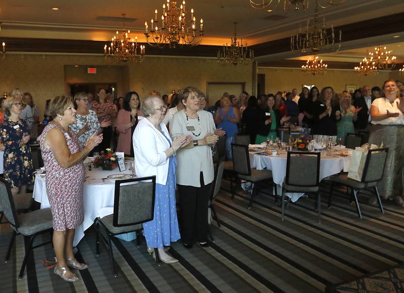 People clap for Lisa Hoeppel during the Northwest Herald's Women of Distinction award luncheon Wednesday June 29, 2022, at Boulder Ridge Country Club, 350 Boulder Drive in Lake in the Hills. The luncheon recognized 10 women in the community as Women of Distinction plus Hoeppel as the first recipient of the Kelly Buchanan Woman of Inspiration award. Hoeppel was a volunteer cheer coach, a volunteer with school and other local organizations, and a substitute teacher. She succumbed to her third battle with breast cancer April 10 at the age of 40.