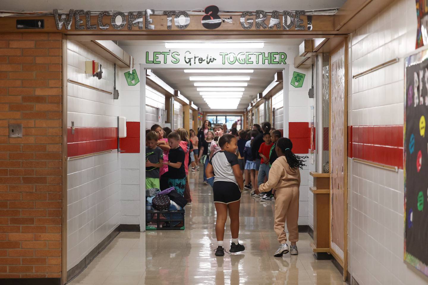 Bradley West Elementary School students walk past encouraging wall displays as they return to class on Sept. 3, 2025.
