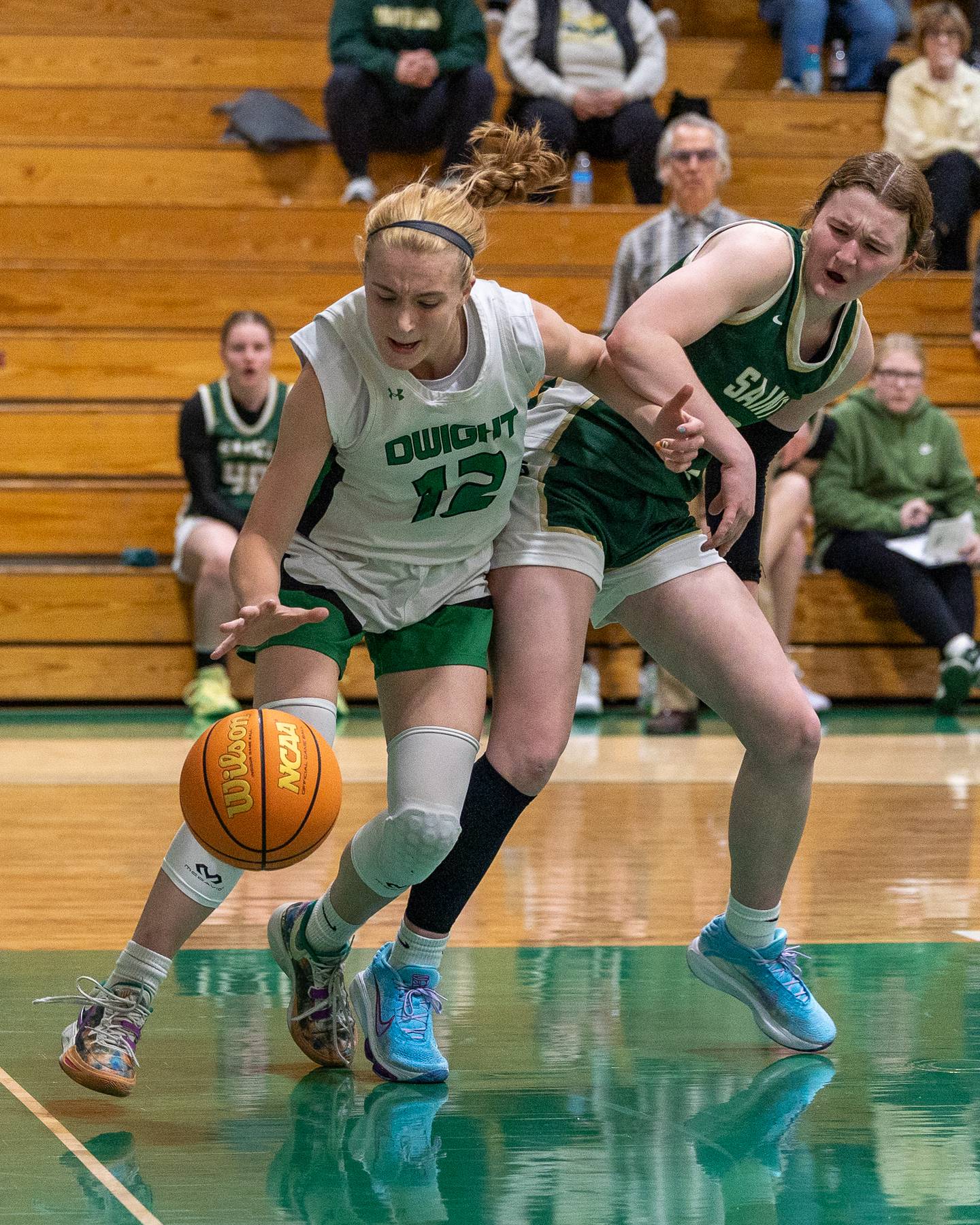 Dwight's Mikayla Chambers (12) pushes away Lili McClain (23) of St. Bede whilst driving towards basket on Monday, January 19, 2026 at the Krese Memorial Gymnasium in Dwight.