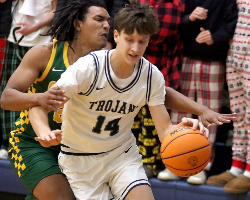 Cary-Grove’s Evan Bauer gets past Crystal Lake South’s Mugi Bayuo in varsity boys basketball on Wednesday, Dec. 3, 2025, at Cary-Grove High School in Cary.