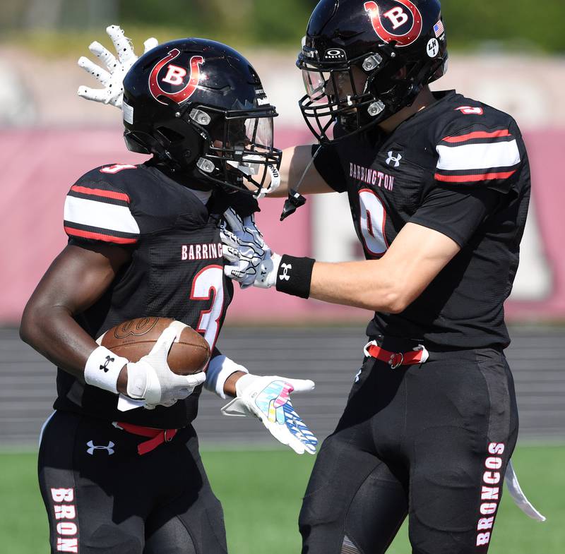 Barrington's Lamar Osterhues, left, celebrates a third-quarter touchdown with teammate Owen Cook during a football game against Palatine on Saturday, Sept. 27, 2025 in Barrington.