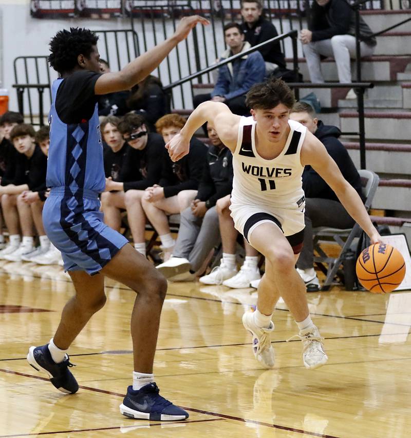 Prairie Ridge's Elijah Loeding (right) pushes the ball up the court against Illinois Math & Science Academy's Omar Njikam during a IHSA Class 3A Burlington Central Regional quarterfinal boys basketball game on Monday, feb23, 20256, at Prairie Ridge High School in Crystal Lake.